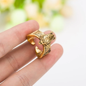 Detailed macro view of an antique gold bat ring featuring intricate wing textures