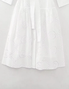 Detailed view of white cotton Broderie Anglaise embroidery and matching fabric belt