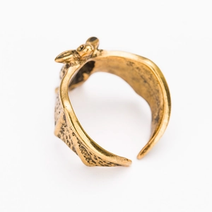 Macro shot of vintage bat-shaped open ring in antique gold finish with detailed wing texture