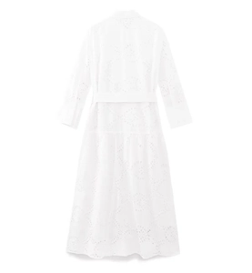 Detailed view of the intricate eyelet embroidery and belt on this white midi dress