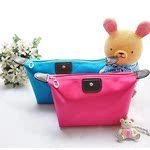 Detail of rose red and blue jacquard cosmetic bags with leather handles and flaps