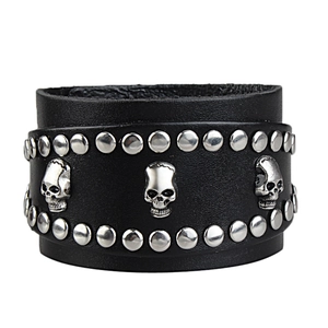 Wide black leather bracelet featuring metallic skulls and rivets on a clean white background