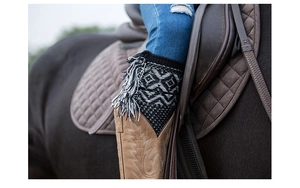 Detail of knitted leg warmers with geometric jacquard pattern and tassel accents on boots