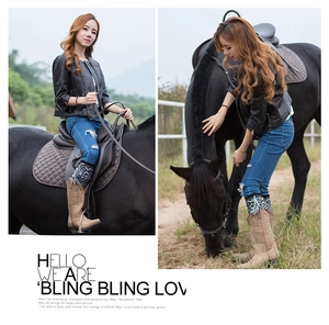 Outdoor fashion style featuring women's slim leather jacket and high brown boots in a ranch