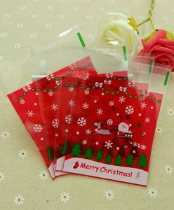 Detail of red Santa Claus and reindeer self-adhesive plastic Christmas cookie bags
