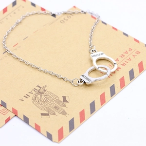 Detail of silver handcuff bracelet with FREEDOM engraving on vintage airmail envelope