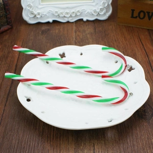 Detail showing red, white and green spiral candy cane ornaments on a decorative plate