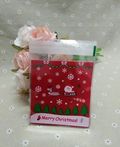 Detail view of Santa Claus and reindeer patterns on a transparent Christmas candy gift bag