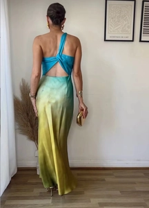 Detail of the backless knot design and gradient satin fabric on the elegant maxi dress