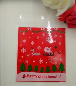 Detail of red Christmas self-sealing plastic cookie bag with Santa and reindeer patterns