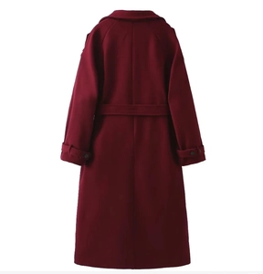 Back view of wine red wool coat featuring a waist belt and buttoned cuffs details