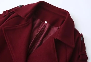 Detail view of burgundy coat showing classic lapels, epaulettes and smooth inner lining