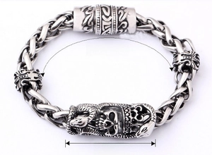 Detail showing vintage 316L stainless steel bracelet with skull and snake carving