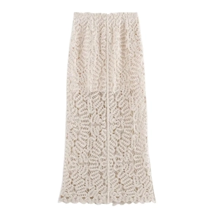 Detail of bohemian crochet knit maxi skirt with intricate floral hollow lace patterns