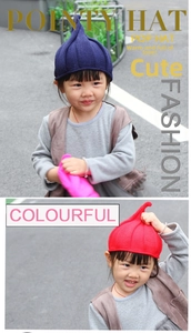 Detail showing red and purple ribbed knit pointy hats for toddlers with spiral tops