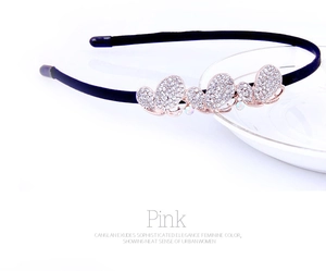 Detail of elegant black headband with three shimmering rhinestone butterflies decorations