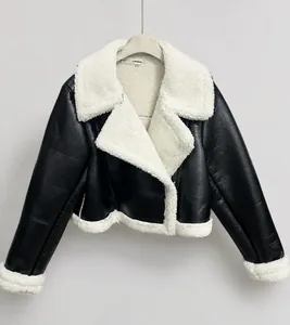 Detail of a black faux leather biker jacket with white shearling trim and collar detail