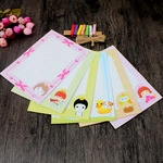 Detailed close-up of colorful cartoon paper frames with clips and rope on wood