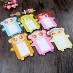 Set of six colorful silicone luggage tags with clear windows on rustic wood background