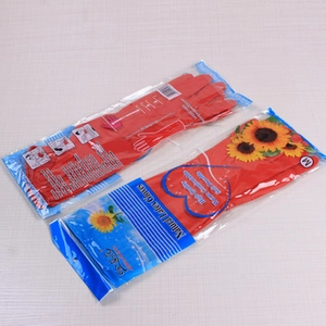 Macro view of red natural latex bath gloves in packaging showing texture and durability