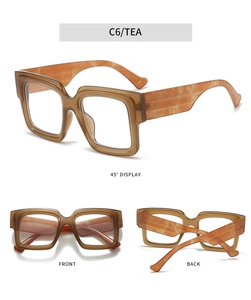 Detailed views of tea-colored square blue light glasses with orange marble temples