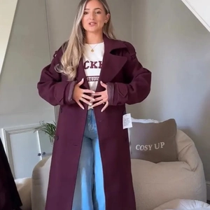 Women's burgundy long wool blend coat with lapel collar and waist belt in casual style