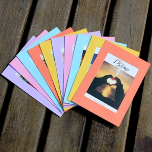 Colorful creative paper photo frames with rope and clips on wooden background