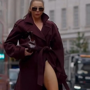 Street style view of deep burgundy wool coat featuring classic wide lapels and waist belt