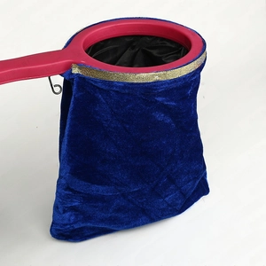 Detail of magic changing bag with blue velvet fabric and gold sequin trim detail