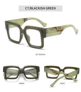Detail view of blackish green square frame glasses with brown marble temple accents