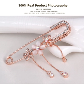Close-up of rose gold floral brooch with pink cat eye stones and sparkling rhinestones