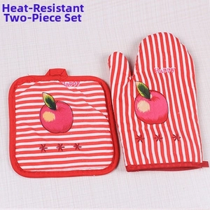 Detail of red striped oven mitt and pot holder set with apple pattern for heat protection