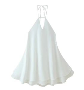 Detail of white halter neck chiffon dress with deep V-neckline and tiered ruffle hemline