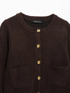 Close-up of brown knit top with premium gold embossed buttons and soft fuzzy texture