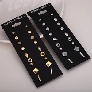Detail shot of various geometric stud earrings displayed on black jewelry cards