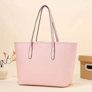 Pink lychee texture tote bag with silver studs and black handles for daily commuting
