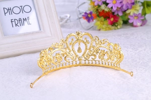 Macro detail of golden baroque crown featuring heart shapes and water drop pendants