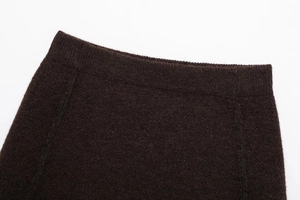 Macro shot of dark brown ribbed knit fabric texture with fine cashmere-like finish