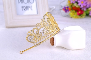 Detailed close-up of Baroque gold tiara with intricate floral rhinestones and side loops
