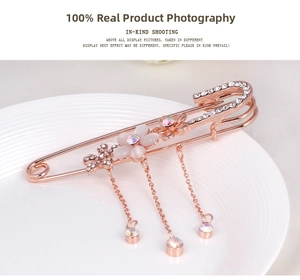 Macro shot of rose gold floral brooch with white opal petals and sparkling tassel chains