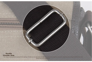 Detail of durable canvas strap with adjustable silver metal buckle and leather trim