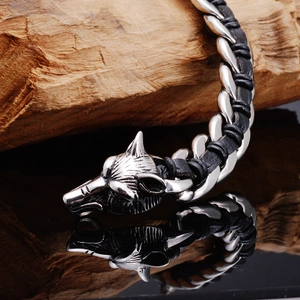 Detail of 316L stainless steel wolf heads clasp and black braided leather bracelet