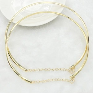 Detail of gold choker necklaces with lobster clasp and extension chain on white fur
