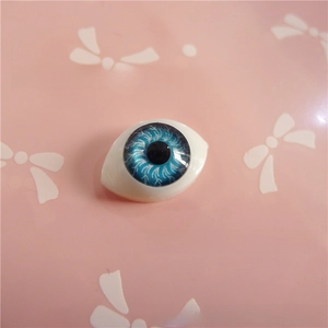 Macro detail of blue acrylic doll eye with realistic iris texture for BJD crafts