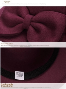 Detail of wool cloche hat showing bow design, 57-58cm size label and fabric texture