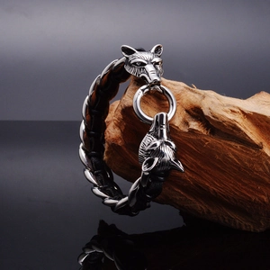 Detail of 316L stainless steel wolf head clasp on a black braided leather bracelet