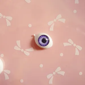 Detail of 10x14mm boat-shaped acrylic doll eyes with purple iris for DIY dolls