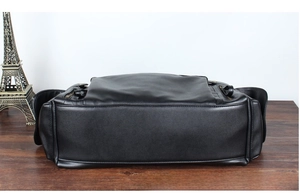 Macro view of matte black PU leather travel bag bottom with reinforced stitching and zipper