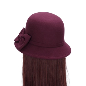 Elegant dark purple wool cloche hat with a double bow accent for women shown on model