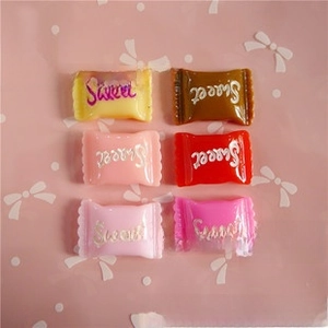 Detailed view of six colorful resin candy charms for DIY jewelry making with Sweet engraving